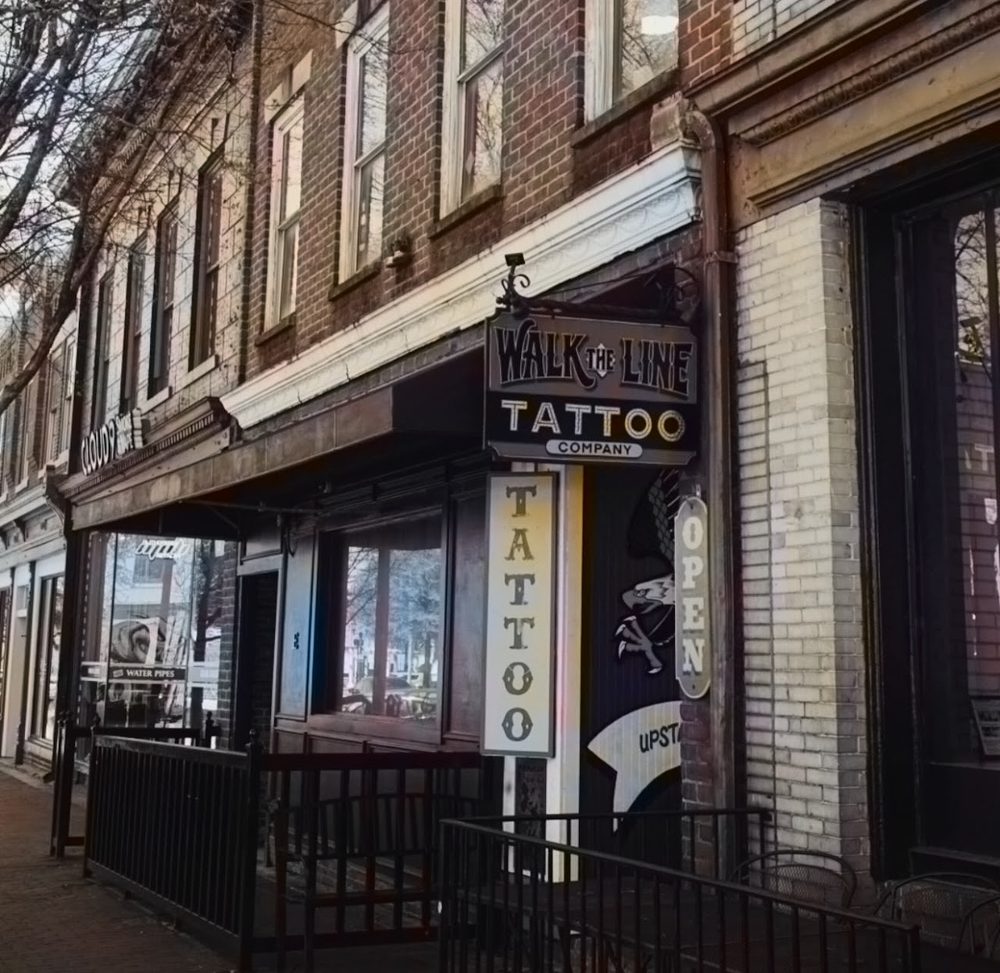 The Walk The Line Tattoo Co. storefront and hanging sign on East Broad Street in Downtown Athens, Georgia
